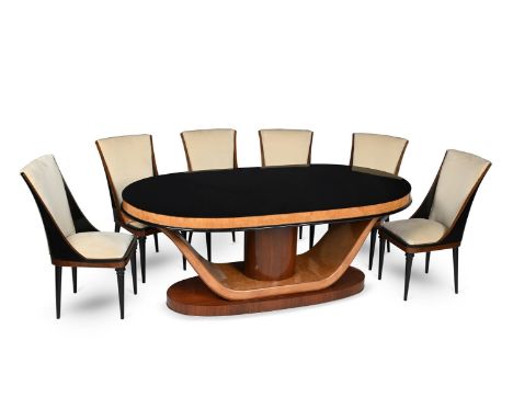 IN THE MANNER OF RUHLMANN AN ART DECO DINING SUITE; CIRCA 1930 Comprising a large oval table with black glass top and six cha