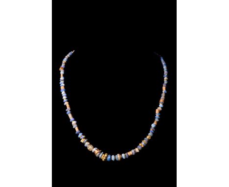 Ca. AD 1-300.A restrung necklace composed of alternating gold and lapis lazuli beads, exhibiting a diverse array of shapes. T