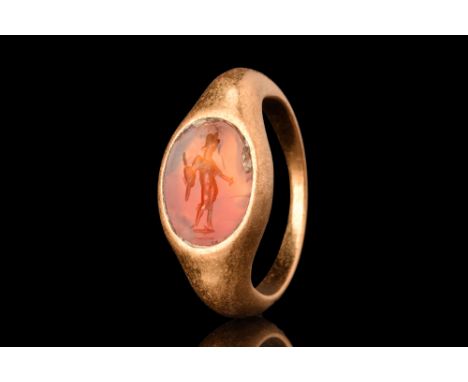 Ca. AD 300.A gold finger ring of Hening type X. Its D-shaped hoop expands gradually to form a recessed setting for a carnelia