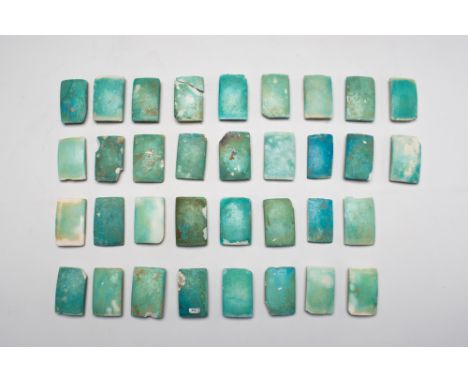 Old Kingdom, 3rd Dynasty, Ca. 2630 - 2611 BC .A group of thirty-four blue glazed composition tiles, each a plaque with remain