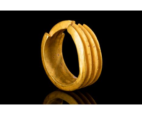 New Kingdom, 18th Dynasty - 19th Dynasty, Ca. 1550-1185 BC.A gold earring modelled with four hollow sheet tubes, triangular i