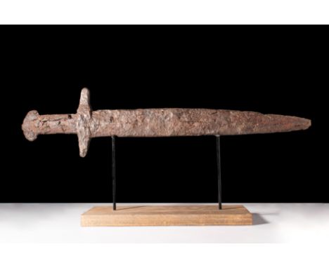 Ca. AD 300.An iron spatha sword with a long tapering, bevelled blade. The blade culminates in a bone hilt with ribbed decorat