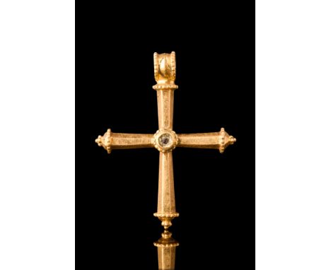 Ca. AD 400-600.A gold cruciform pendant with four hollow polygonal arms tapering inwards. At the centre, a circular raised se