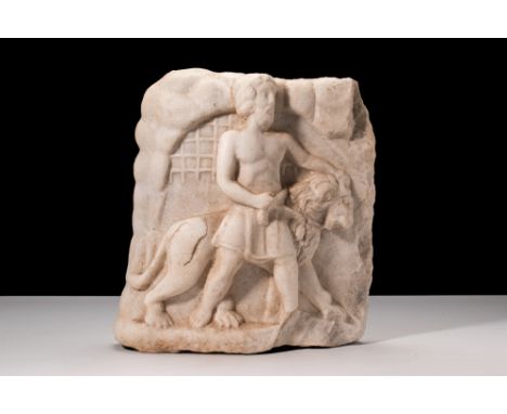 Ca. 1st–2nd Century AD.A marble panel featuring a relief scene of a male figure leading a subdued lion. The man is barefoot a