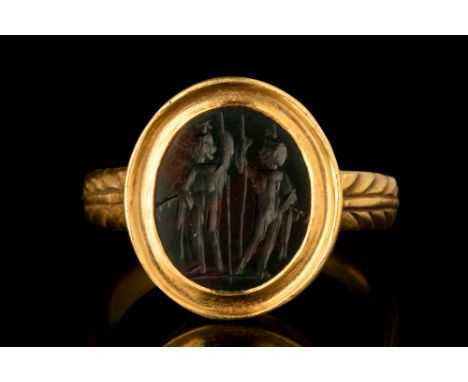 Ca. AD 100-300.A large oval-shaped bloodstone intaglio showcasing an intricate engraving of the Dioscuri. This intaglio portr