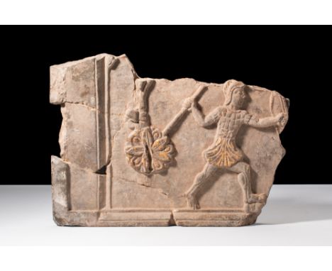 Ca. 6th century BC.A relief panel, preserved in the left bottom corner, representing a scene featuring a warrior. Positioned 