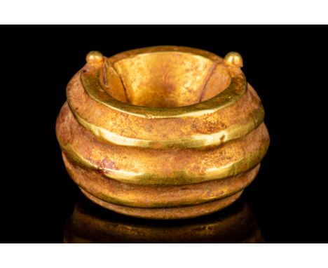 Ca.1000 BC.A delicately modelled Western Asiatic solid gold hair ring with twin hinges. Gold hair rings of this type would ha