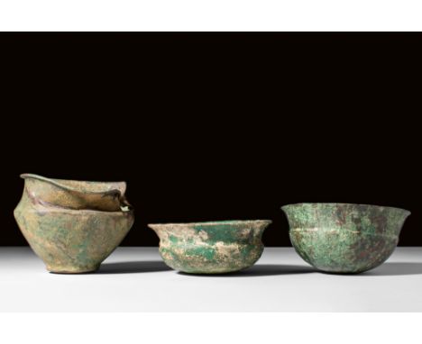 Ca. 5th century BC.A group of three bronze vessels showcasing the diverse forms in ancient Etruscan craftsmanship. The first 