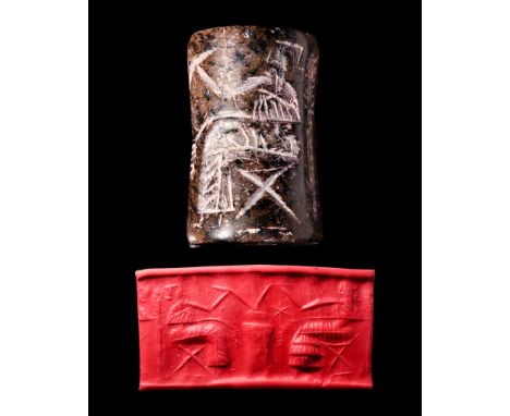 Ca. 2700-2300 BC. A black stone cylinder seal depicting a banquet scene with seated male and female figures drinking from a l