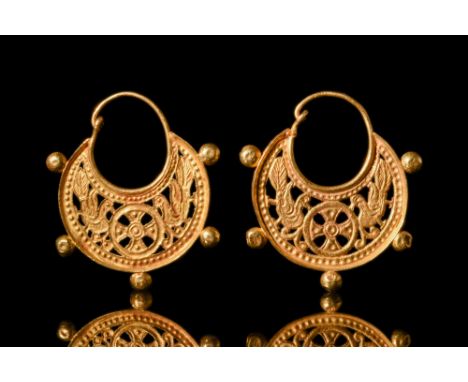 Ca. AD 700-800.An open-work matched pair of gold earrings in a crescent shape, with hook and eye closure. Each plaque feature