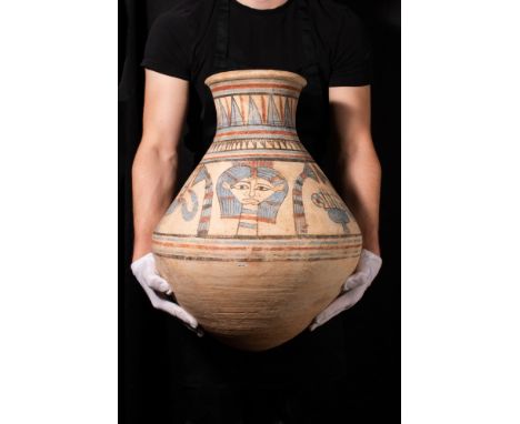 New Kingdom, Reign of Akhenaton, Ca. 1352 - 1336 BC.A large reddish-buff pottery jar of approximately bi-conical shape with h