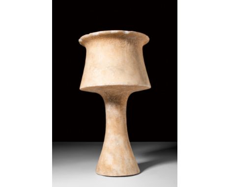 Ca. 3100-2500 BC. A stone carved chalice with a tall stem and a conical base topped with a bowl with slightly flaring walls. 