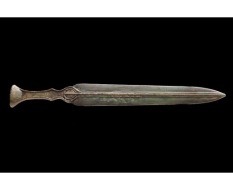 Western Asiatic/Aegan, Ca. 1200-700 BC.A bronze dagger with a slender double-edged blade tapering to a sharp point. The hilt 