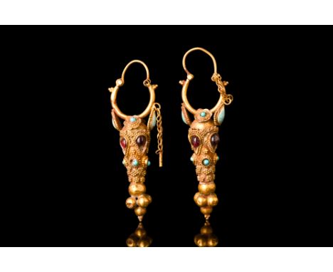 Ca. 2nd century AD.A matching pair of gold earrings each composed of a thick hinged hoop, closed by a gold pin secured on a c