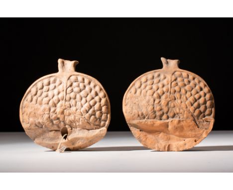 Hellenistic, 300 - 100 BC.A votive offering moulded from terracotta in the shape of a pomegranate which has been cut open int