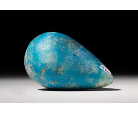 Middle Kingdom, Ca. 2055 - 1773 BC.A hollow dark green glazed faience egg-shaped ball, perhaps a model of a fig. For addition