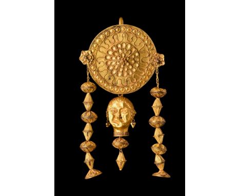 Possibly Hellenistic, Ca. 400 BC or later .A gold earring featuring a large circular plaque intricately decorated with filigr
