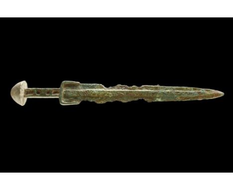 Western Asiatic/Aegan, Ca. 1200-700 BC.A bronze sword with a triangular-shaped blade that tapers to a sharp point and feature