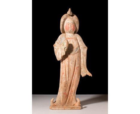 Tang Dynasty, Ca. AD 618-907.A ceramic figure known as the 'Fat Lady', seen standing in a graceful pose, her curvaceous body 