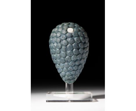 New Kingdom, Ca. 1550 - 1069 BC.An example of an Egyptian faience grape cluster. The piercing at the top would allow attachme