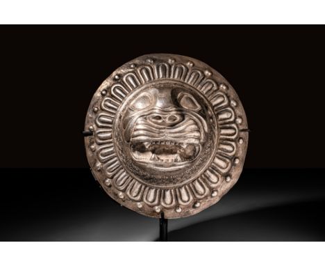 Possibly Sassanian Ca. AD 600 or later.A discoid silver mount featuring a central repoussé lion head depicted en face. The an
