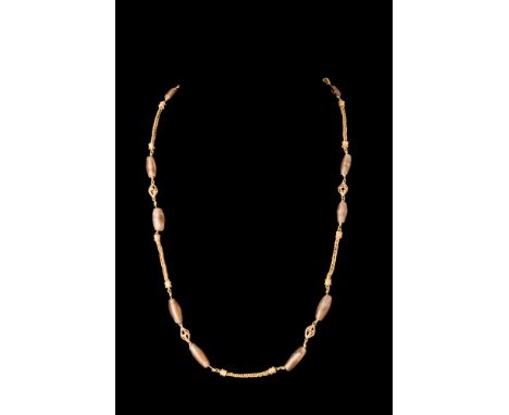 Ca. AD 100-300.A sophisticated gold necklace composed of a symmetric arrangement of short gold chains with a loop-in-loop des