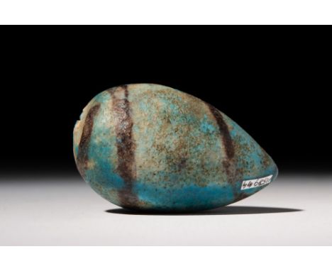 Middle Kingdom, Ca. 2055 - 1773 BC.A hollow dark green glazed faience egg-shaped ball, perhaps a model of a fig. For addition