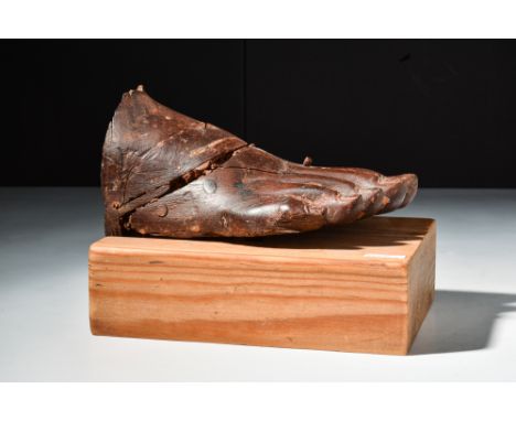 Late Dynastic Period, Ca. 664 - 332 BC.A wooden fragment from a statue in the form of a foot and ankle which has been forged 