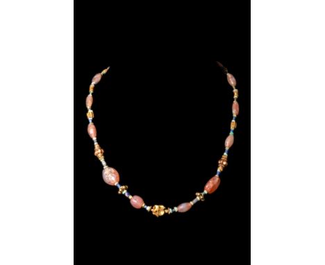 Ca. AD 1-300.A restrung necklace formed of large, red stone beads which are interspersed with arrangements of blue and turquo