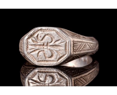 Ca. AD 1100-1400.A silver seal ring featuring a round hoop with widened and incised shoulders, seamlessly merging into an oct