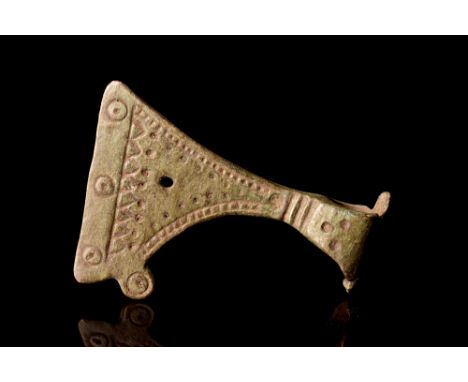 Ca. AD 900-1100.A bronze example of an axe or Perun amulet comprising a suspension loop through its socket and a stylised bla