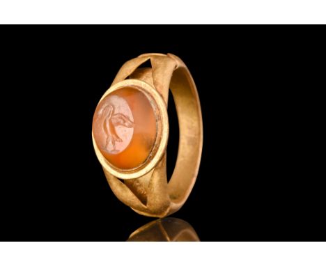 Ca. AD 100-200.A gold finger ring adorned with a convex carnelian intaglio engraved with a profile view of a goose, its wings