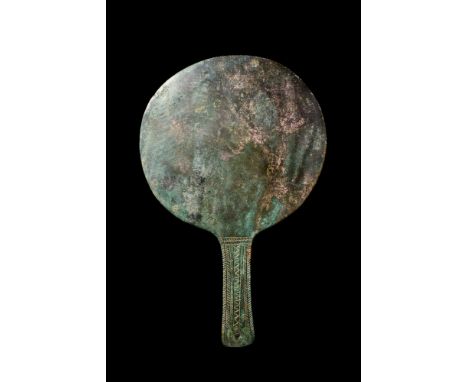 Ca. 400 BC.A bronze mirror of a circular form with a flattened, rectangular-projecting handle featuring a rounded end and etc