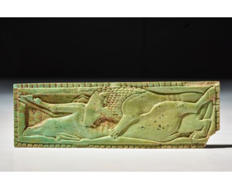 Graeco-Roman, Ca. 30 BC .A glazed faience tile-shaped inlay in rectangular form with central scene of a lion with thick mane 