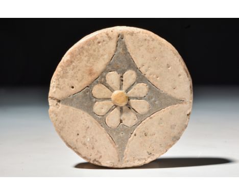 New Kingdom, 20th Dynasty,Ca. 1184 - 1153 BC.A glazed faience composition set with x-shaped design and creamy brown petals on