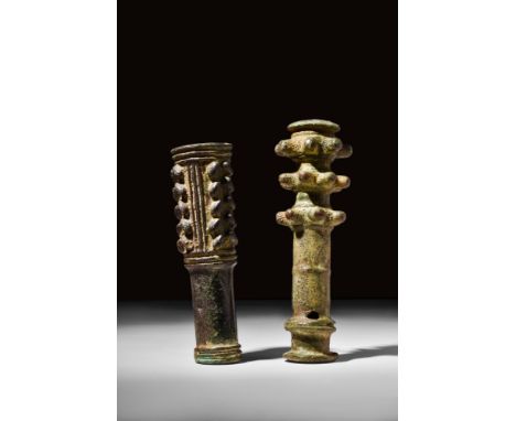 Ca. 1200-700 BC.A pair of cast bronze mace heads, each with a hollow cylindrical body to be placed around a wooden staff. The