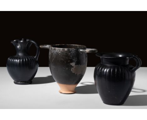 Ca. 450 BC.A group of three distinctive Attic black-glazed vessels including: a trefoil oinochoe, standing on a ring base and