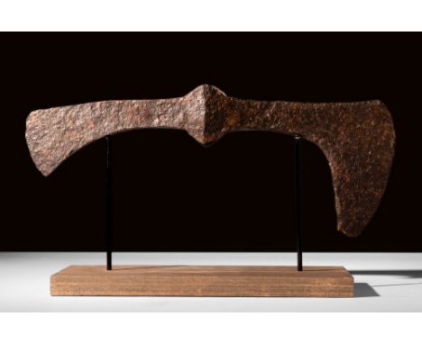 Ca. AD 900-1100.A double-bladed iron battle axe with a reinforced socket and elongated cheek culminating in a bearded-type bl