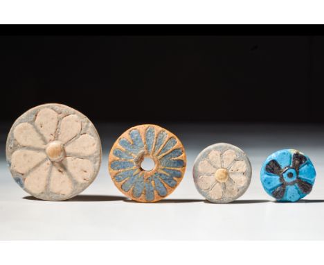New Kingdom, 20th Dynasty, Ca. 1186 - 1069 BC.A group of four circular, glazed faience tiles with delicate a rosette flower d
