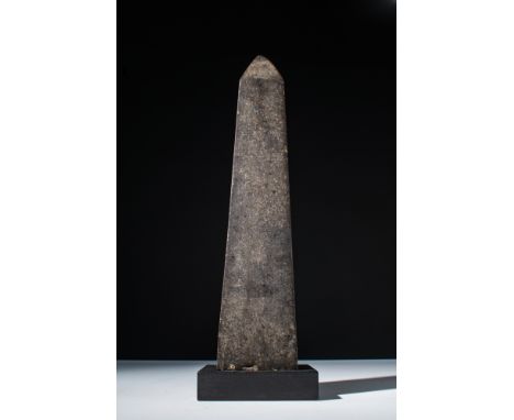 New Kingdom, Ca. 1550 - 1070 BC.A pyramidion and upper shaft of a small obelisk, made of brown stone. Possibly inserted into 