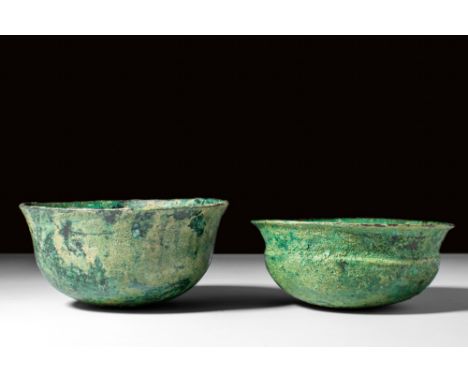 Ca. 5th century BC.A pair of bronze vessels including a bowl with a round bottom, and a flaring profile. The second bowl, sha