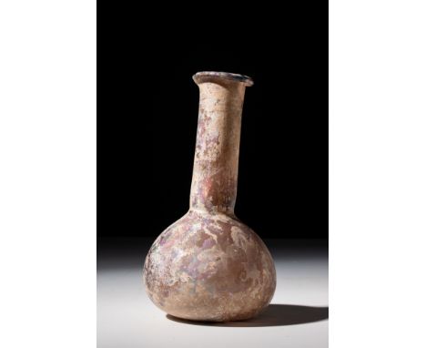 Ca. AD 200 - 300 .A blown glass flask, unguentarium or 'candlestick'. A bulbous triangular body on a flat base (concave under