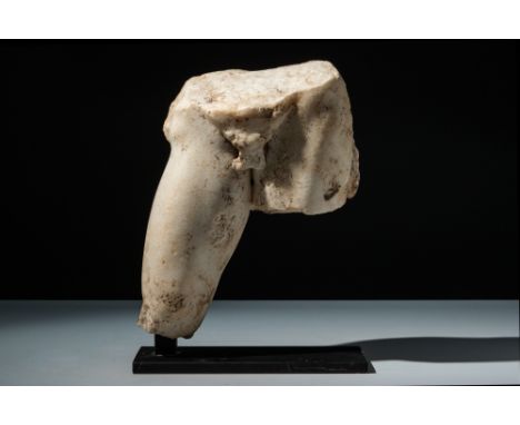 Ca. 1st-2nd Century AD.A fragmentary Roman marble statue, depicting the buttocks and legs of a male youth. Remaining details 