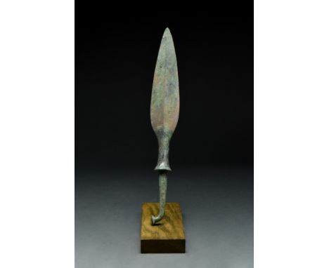 Ca. 1st millennium BC.A bronze spearhead featuring a leaf-shaped blade with rounded shoulders and a prominent midrib that run