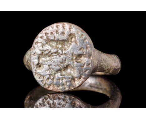 Ca. AD 100-300.A bronze seal finger ring characterized by a slender round hoop which seamlessly merges with a circular bezel.