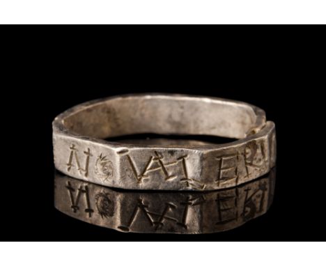 Ca. AD 400.A silver finger band with a polygonal profile featuring letters inscribed on each facet. Silver rings were reserve