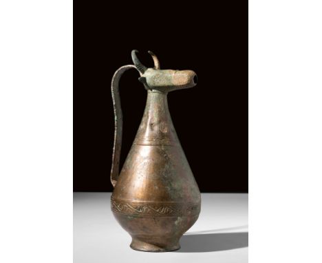 Ca. 12th-13th century AD.A bronze ewer with a distinctive design of a piriform body elevated on a short concave foot. The spo