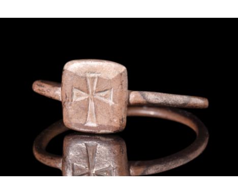 Ca. 6th-7th century AD.A silver finger ring with a wire looped into a shank and soldered onto a flat square-shaped bezel whic