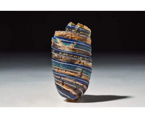 Ca. 100 BC.A fragment from the bottom of a beautful gold-banded Roman glass alabastron with round connical shaped body in a t