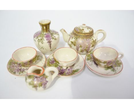 Japanese meiji satsuma nine piece set including an ovoid lidded tea pot, vase, milk jug, three cups and saucers each painted 
